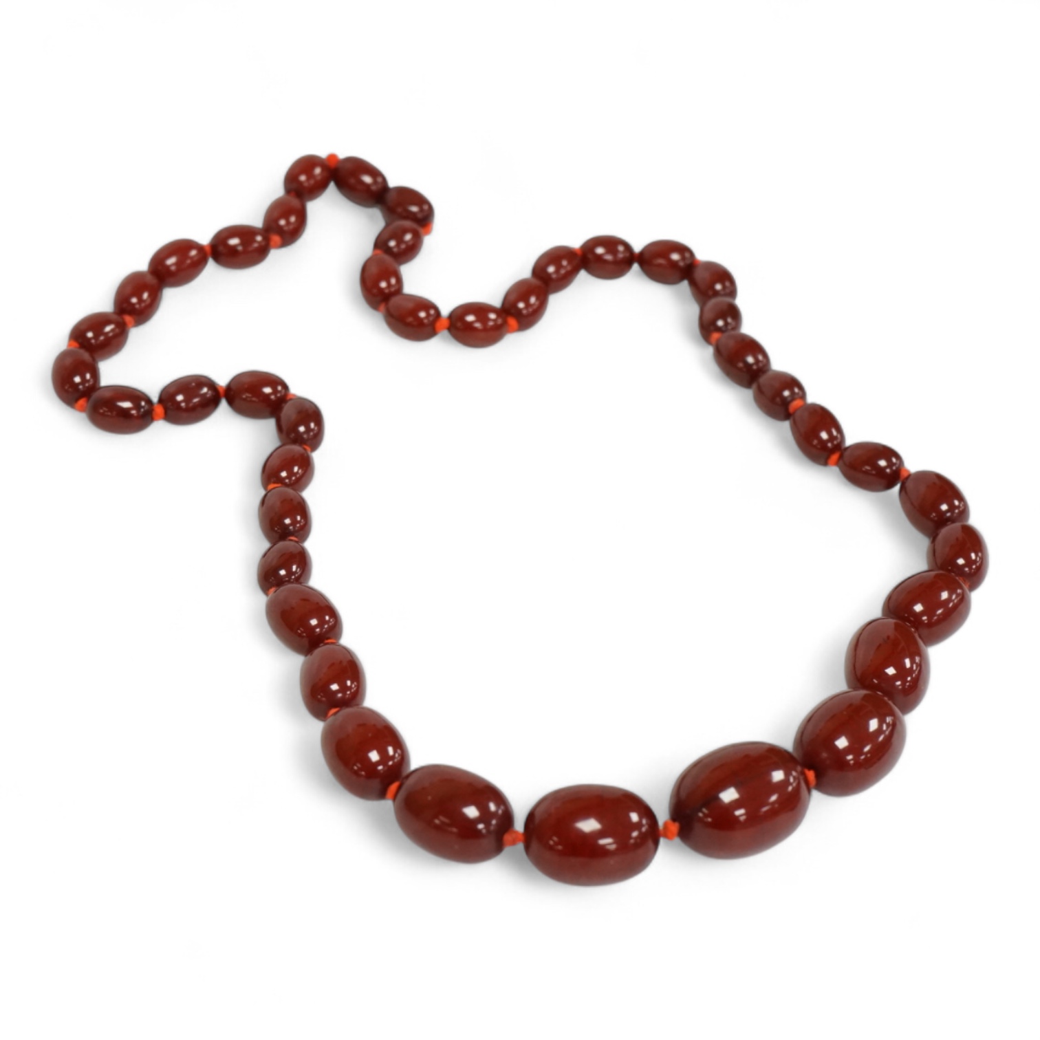 A single strand graduated simulated oval cherry amber bead necklace, 72cm, gross weight 100 grams.